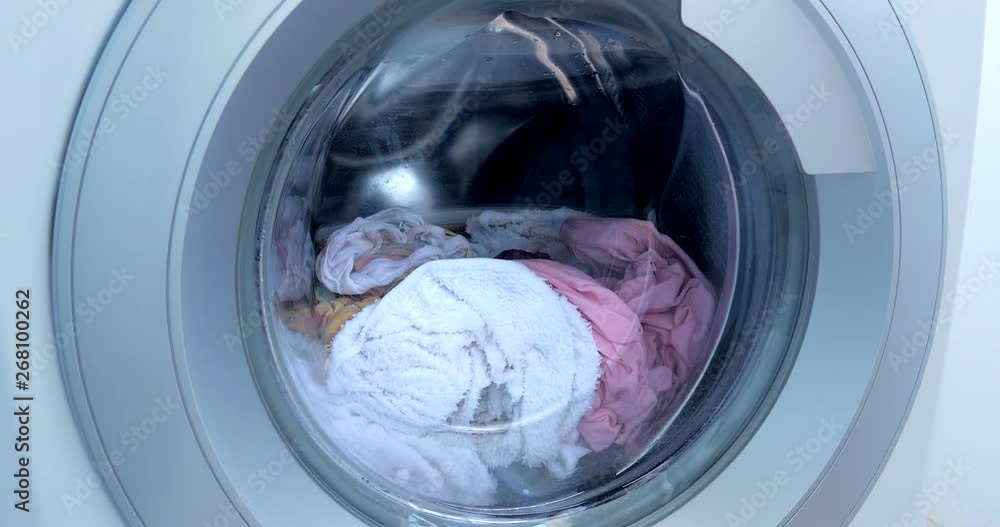Loading the washing machine. Industrial Washing Machine Washes Colored Clothing and White Linen, White Striped Clothing. Cylinder Spinning Machine. Concept Washing Machine, Industry Laundry Service. Loading the washing machine. Industrial Washing Machine Washes Colored Clothing and White Linen, White Striped Clothing. Cylinder Spinning Machine. Concept Washing Machine, Industry Laundry Service.