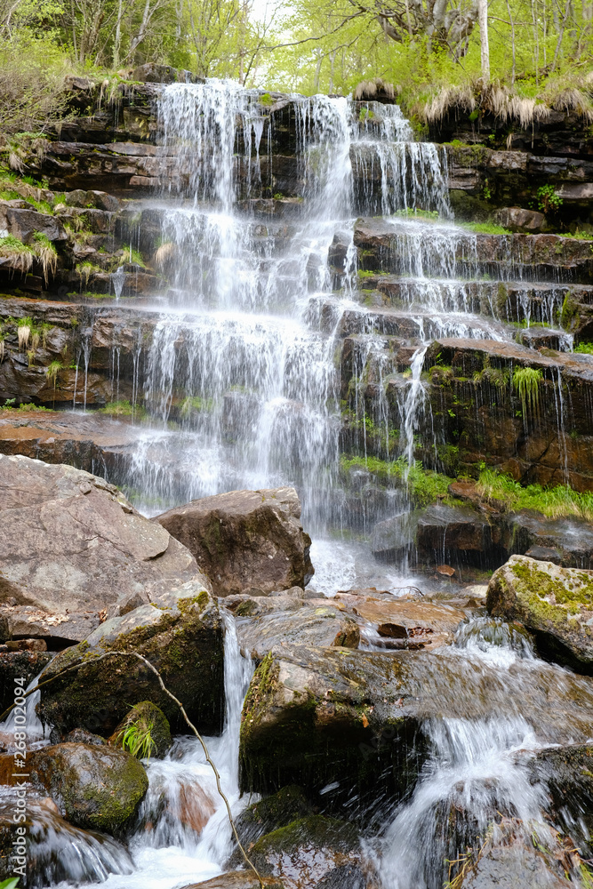 Amazing waterfall in the mountains, springtime Amazing waterfall in the mountains, springtime