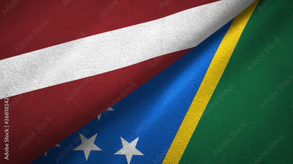 Fototapeta premium Latvia and Solomon Islands two flags textile cloth, fabric texture