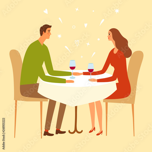 Pair sitting in a restaurant and holding hands.