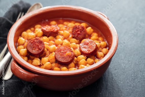 chick pea with smoked sausage in ceramic dish