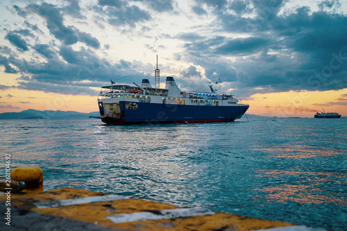 Travel by Greece. Beautiful sunset landscape with big ferry and sea wharf. © luengo_ua