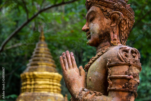 Buddha Statue Overlooking Stupa