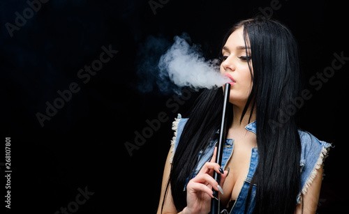 sexy woman smoking cigar. Bad habit. Woman vapor. unhealthy addiction. Tabacco drug. exhale smoke on black background. hookah bar. Electronic cigarette. copy space. Be Healthy, dont do drugs