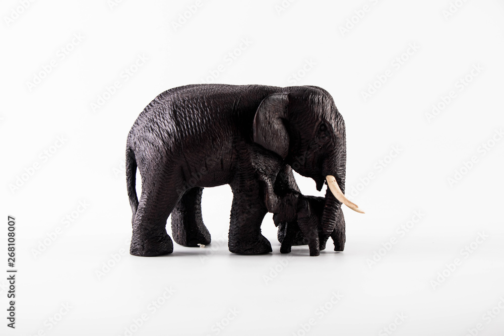 Fototapeta premium Elephant family carved from wood