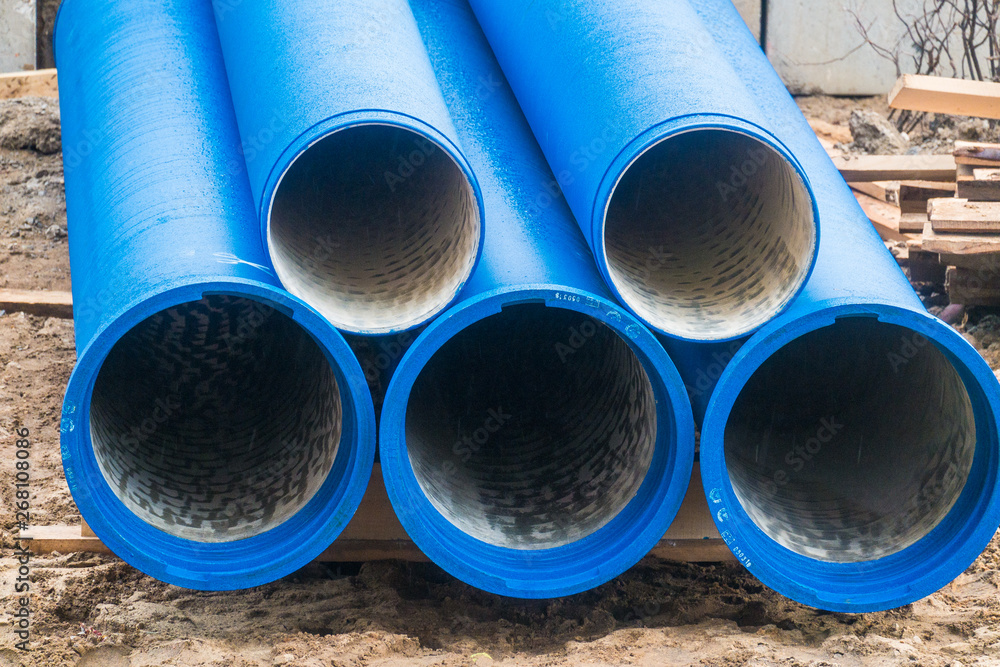 Big blue water pipes on the construction site.Repair of water supply networks Big blue water pipes on the construction site.Repair of water supply networks