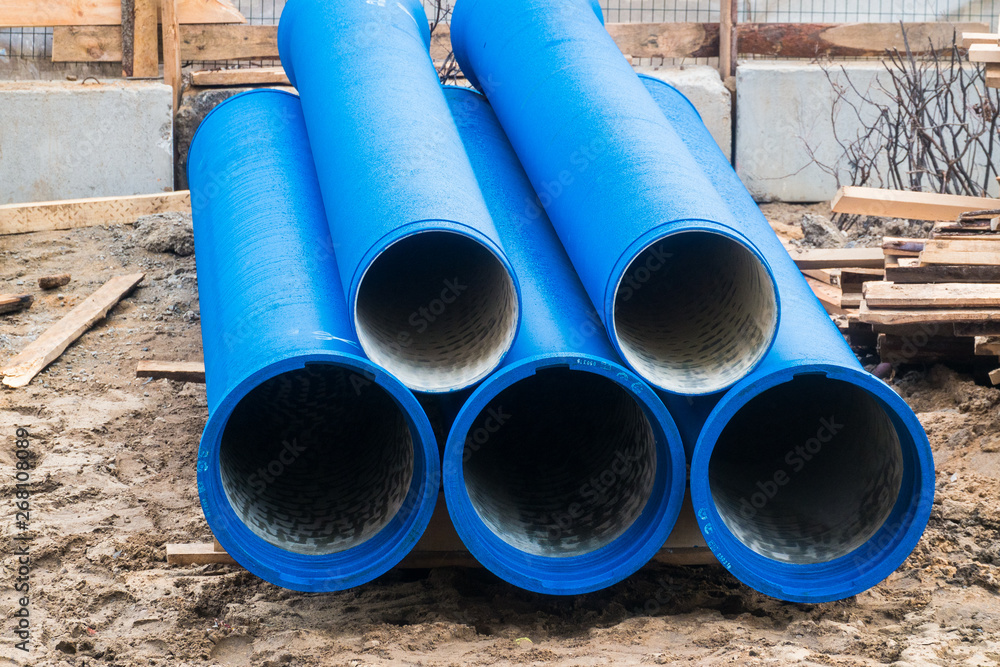 Big blue water pipes on the construction site.Repair of water supply networks Big blue water pipes on the construction site.Repair of water supply networks