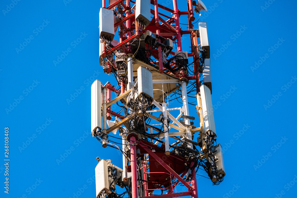 A fragment of a cell tower close-up against the blue sky.Modern telecommunication equipment.4G networks A fragment of a cell tower close-up against the blue sky.Modern telecommunication equipment.4G networks