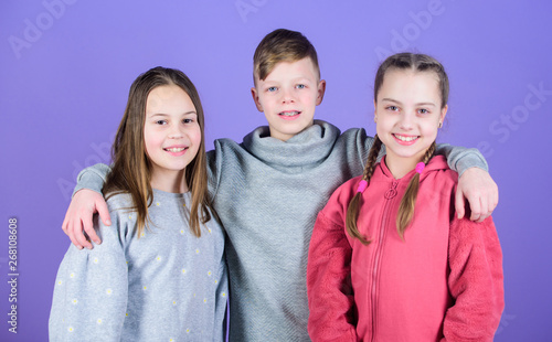 Fun time with friends. childhood friendship. family bonds. team work concept. having fun together. support. little girls sister and boy. sportswear fashion. childrens day. friends children embrace
