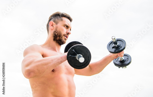 Training to be the best. success. Perfect biceps. fitness and sport equipment. man sportsman with strong hands. steroids. athletic body. Dumbbell gym. Muscular man exercising in morning with barbell