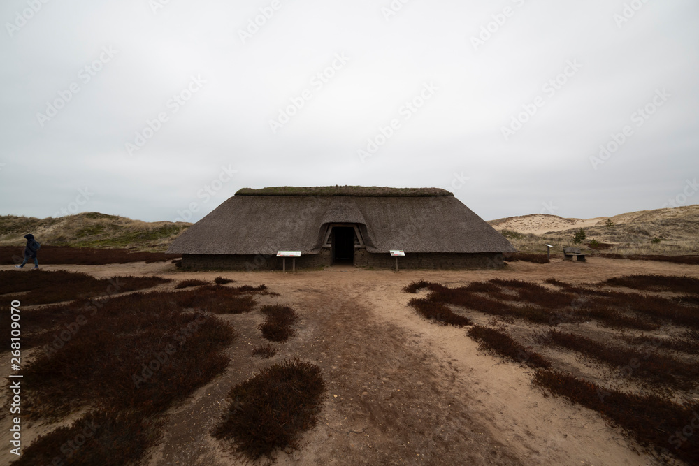Viking glacier house between the sand dunes against cloudy sky Viking glacier house between the sand dunes against cloudy sky