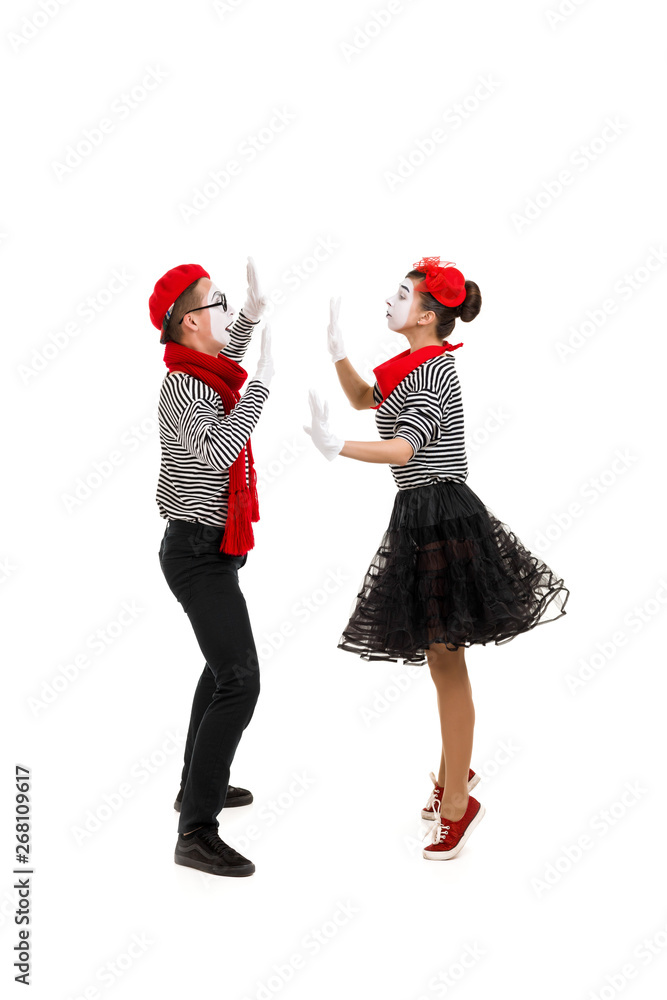 mimes in striped shirts. Male and female mimes dancing isolated on white background mimes in striped shirts. Male and female mimes dancing isolated on white background