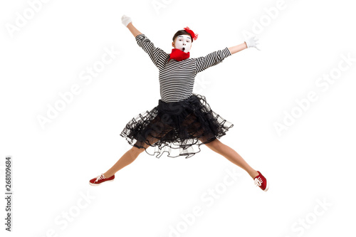 Full length portrait of mime woman artist jumping isolated on white background