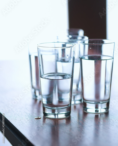 Group of glasses on table filled with still mineral water