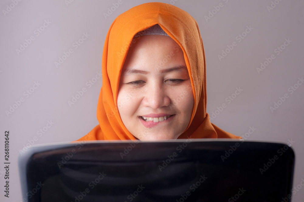 Woman With Naughty Expression Looking at Laptop Woman With Naughty Expression Looking at Laptop