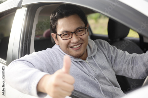 Happy Driver Shows Thumb Up and Smile © airdone