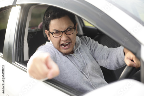 Angry Asian Male Driver, Screaming Pointing From His Car © airdone
