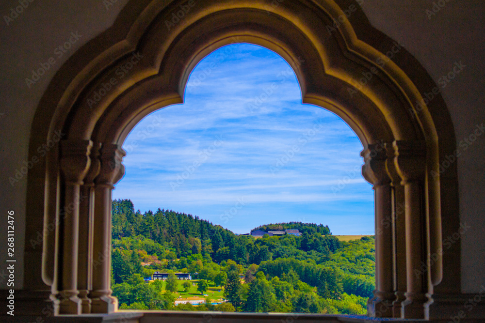 View of the mountain and forest in Vianden, Luxembourg, from an arch inside the Vianden Castle
