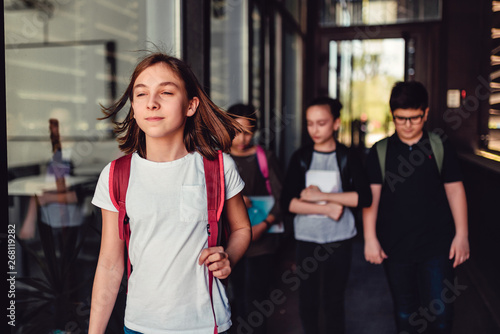 Girl going to the school with classmates