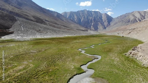 4k aerial fly over river in green high altitude valley in dry valley in Ladakh in India