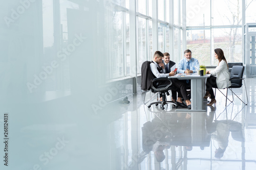 Businesspeople discussing together in conference room during meeting at office. photo