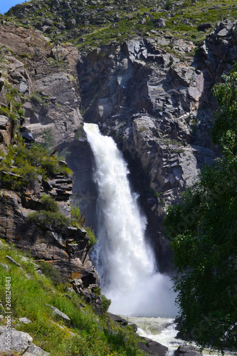 Altai waterfall in rocks on a sunny summer day.
