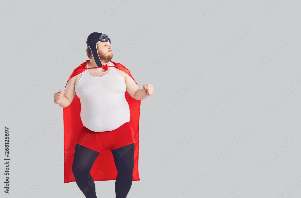 Funny fat man in a superhero costume dancing Stock Photo | Adobe Stock
