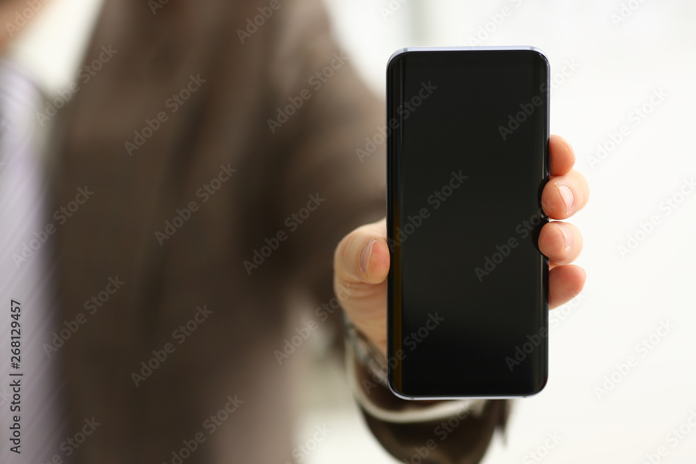 Male arm in suit show in camera phone display screen closeup. Read news mania send sms chat addict use electronic bank modern lifestyle job plan colleague share blog tweet web application search