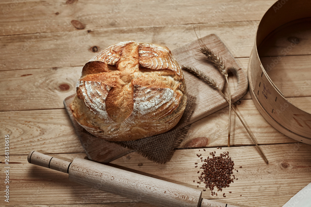 Freshly baked bread on wooden background. Bread at leaven. Unleavened bread. Freshly baked bread on wooden background. Bread at leaven. Unleavened bread.