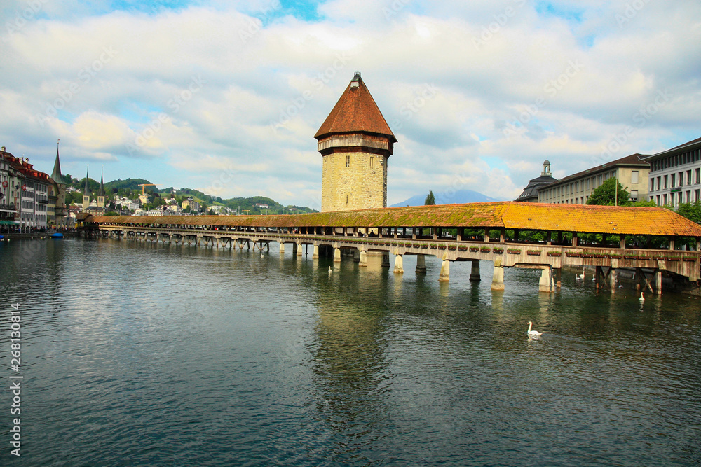 Famous Chapel bridge (The Kapellbrücke) in Lucerne in a beautiful summer cloudy day in Switzerland 