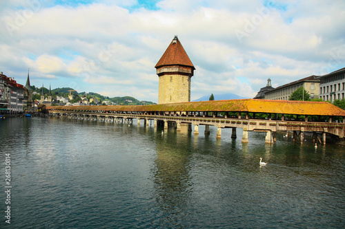 Famous Chapel bridge (The Kapellbrücke) in Lucerne in a beautiful summer cloudy day in Switzerland 