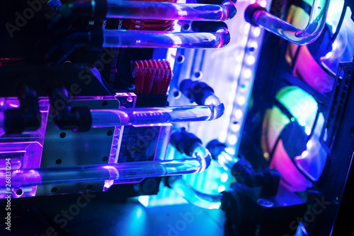 Inside a high performance computer. Computer circuit board and CPU cooling fans illuminated by internal LEDs inside a server class computer.