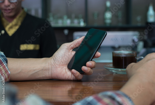 Man using smartphone at coffee shop