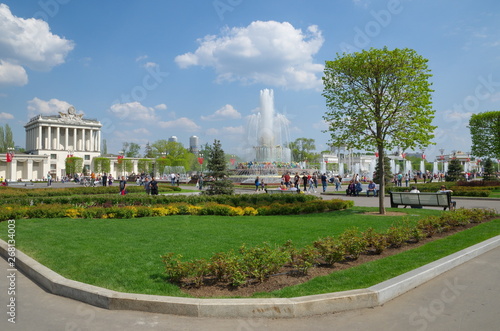 Moscow, Russia - may 7, 2019: Spring view of the fountain "Stone flower" and pavilion № 64 "Optics" at VDNH