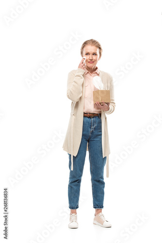 sad middle aged woman crying and wiping face with tissue Isolated On White