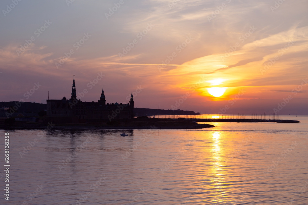 Kronborg castle silhouette in Helsingor at sunset, Denmark. Castle on the shore in Helsingor. Danish harbour of Helsingor with Kronborg castle. Panoramic view to Kronborg castle, Helsingor, Denmark. Kronborg castle silhouette in Helsingor at sunset, Denmark. Castle on the shore in Helsingor. Danish harbour of Helsingor with Kronborg castle. Panoramic view to Kronborg castle, Helsingor, Denmark.