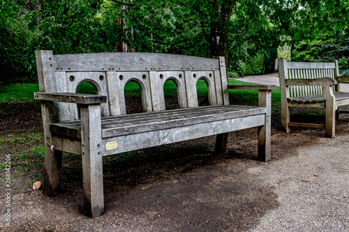 old wooden bench in the part bekween trees