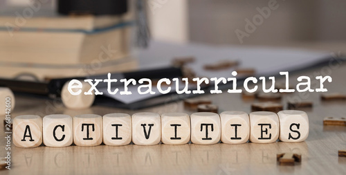 Words EXTRACURRICULAR ACTIVITIES composed of wooden dices.