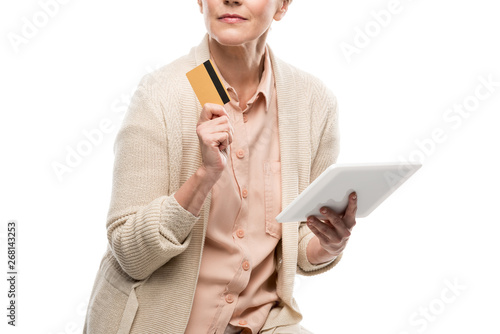 cropped view of middle aged woman with credit card and Digital Tablet Isolated On White