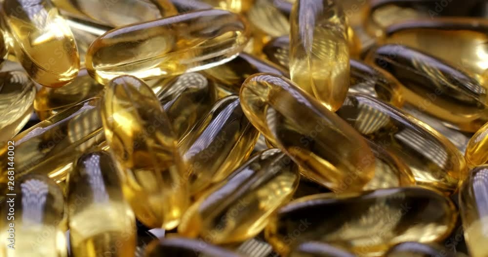 Macro view: Vitamins supplements pills omega 3. Fish oil capsules. 4k. 50fps Macro view: Vitamins supplements pills omega 3. Fish oil capsules. 4k. 50fps
