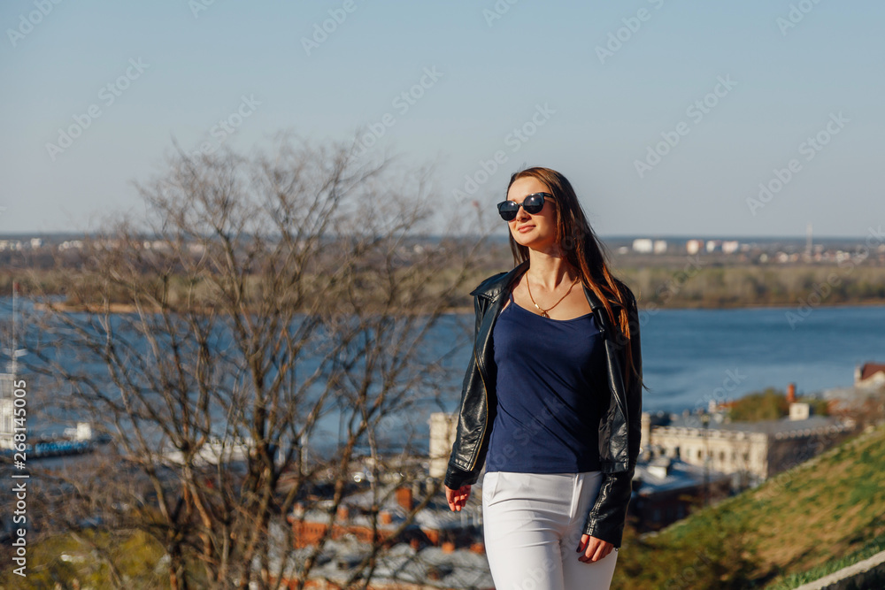 stylish girl in sunglasses with long hair and a leather jacket stylish girl in sunglasses with long hair and a leather jacket