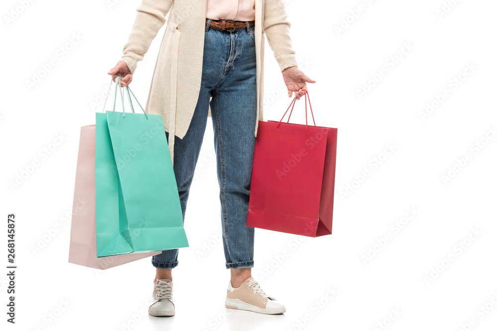 Cropped view of middle aged woman with shopping bags on White