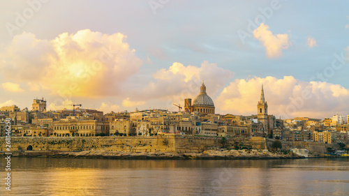 Skyline at beautiful sunrise from Sliema with churches of Our Lady of Mount Carmel and St. Paul's Anglican Pro-Cathedral. Panoramic view of Valletta city - the Capital of Malta. © prystai