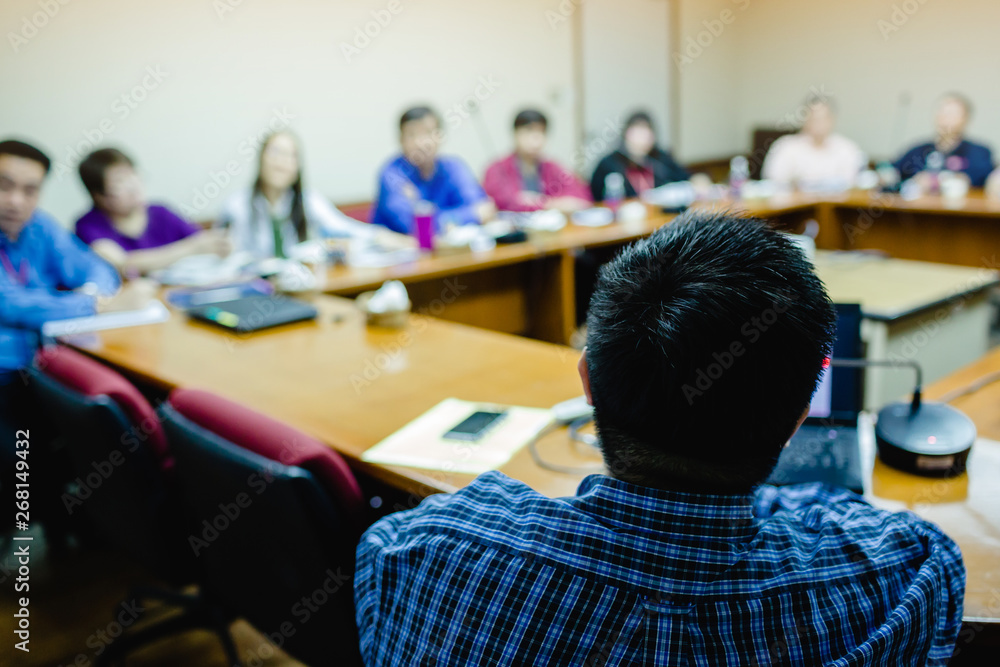 business man is presenting with computer laptop and microphone in conference room business man is presenting with computer laptop and microphone in conference room