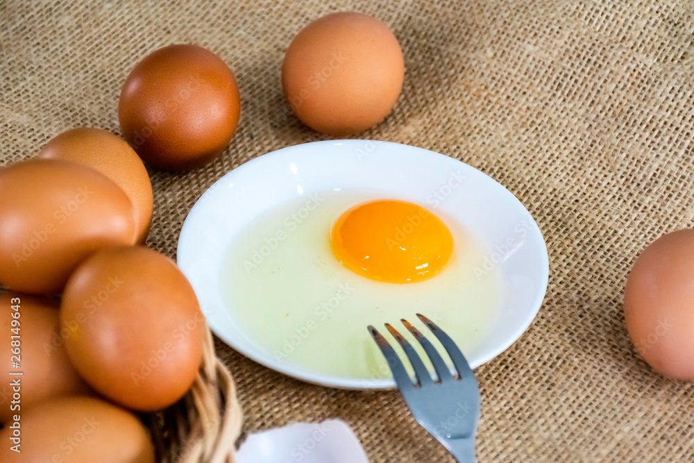 Fresh farm eggs with yolk on bowl Fresh farm eggs with yolk on bowl