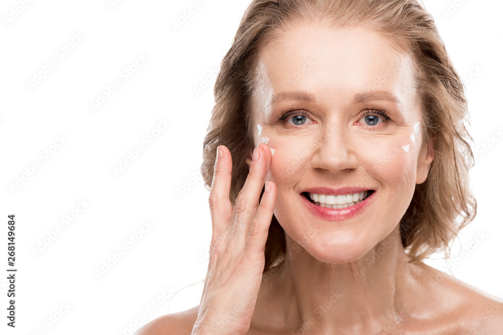 mature woman applying cosmetic cream on face Isolated On White mature woman applying cosmetic cream on face Isolated On White