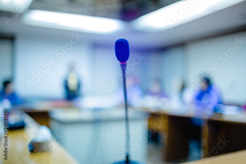 Soft focus of desktop wireless Conference microphones with blurry business group in a meeting room, microphone on the desk in meeting room