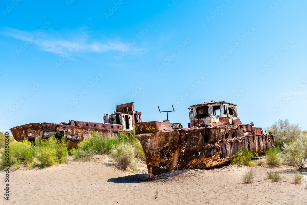 A rusting shipwreck in the desert near the former Aral Sea fishing town Moynaq / Muynaq in Uzbekistan / Karakalpakistan