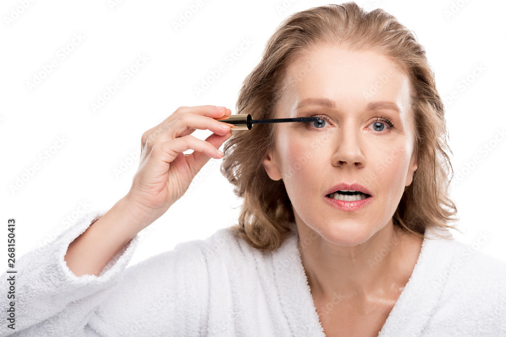 beautiful mature woman applying mascara Isolated On White beautiful mature woman applying mascara Isolated On White