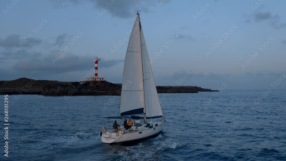 Yacht Sailing Aerial 4k video. Flying drone view of Boat Sailing. Sunset on the Atlantic Ocean. Canary beach paradise island with aqua blue Sky Sea Water
